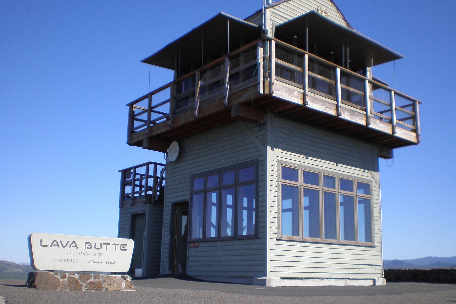 Fire lookout tower on the summit of Lava Butte under a clear blue sky