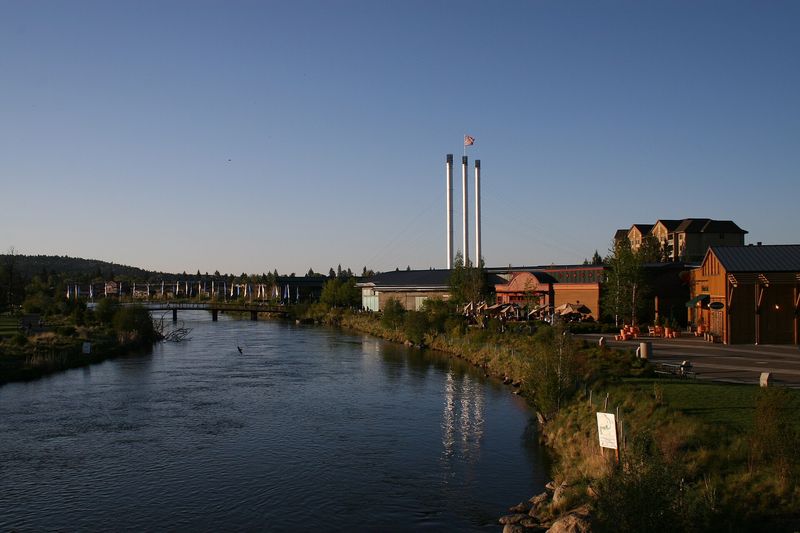 The Deschutes River and the Old Mill District smokestacks at dusk
