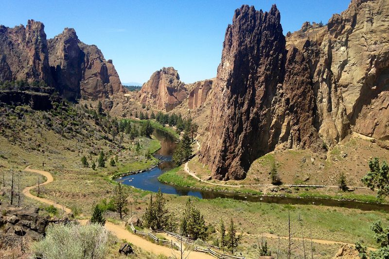 Smith Rock's orange cliffs above the Crooked River bend in afternoon light