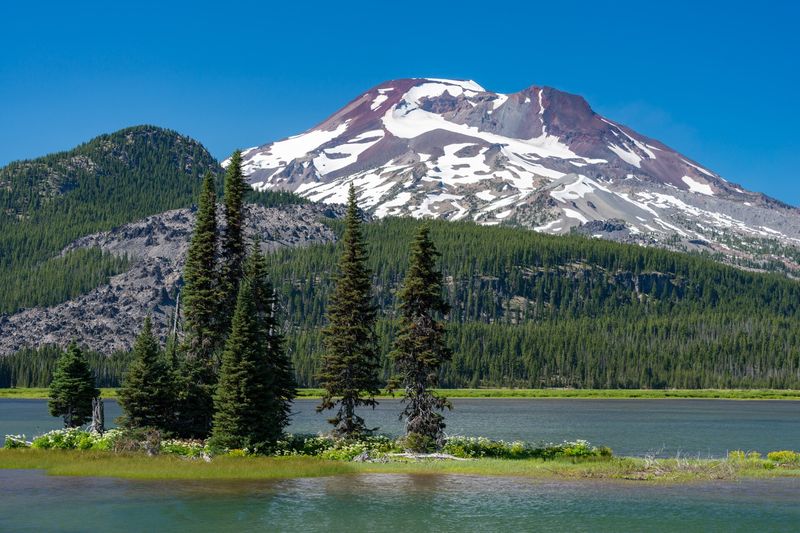 South Sister reflected above Sparks Lake with small pine islands