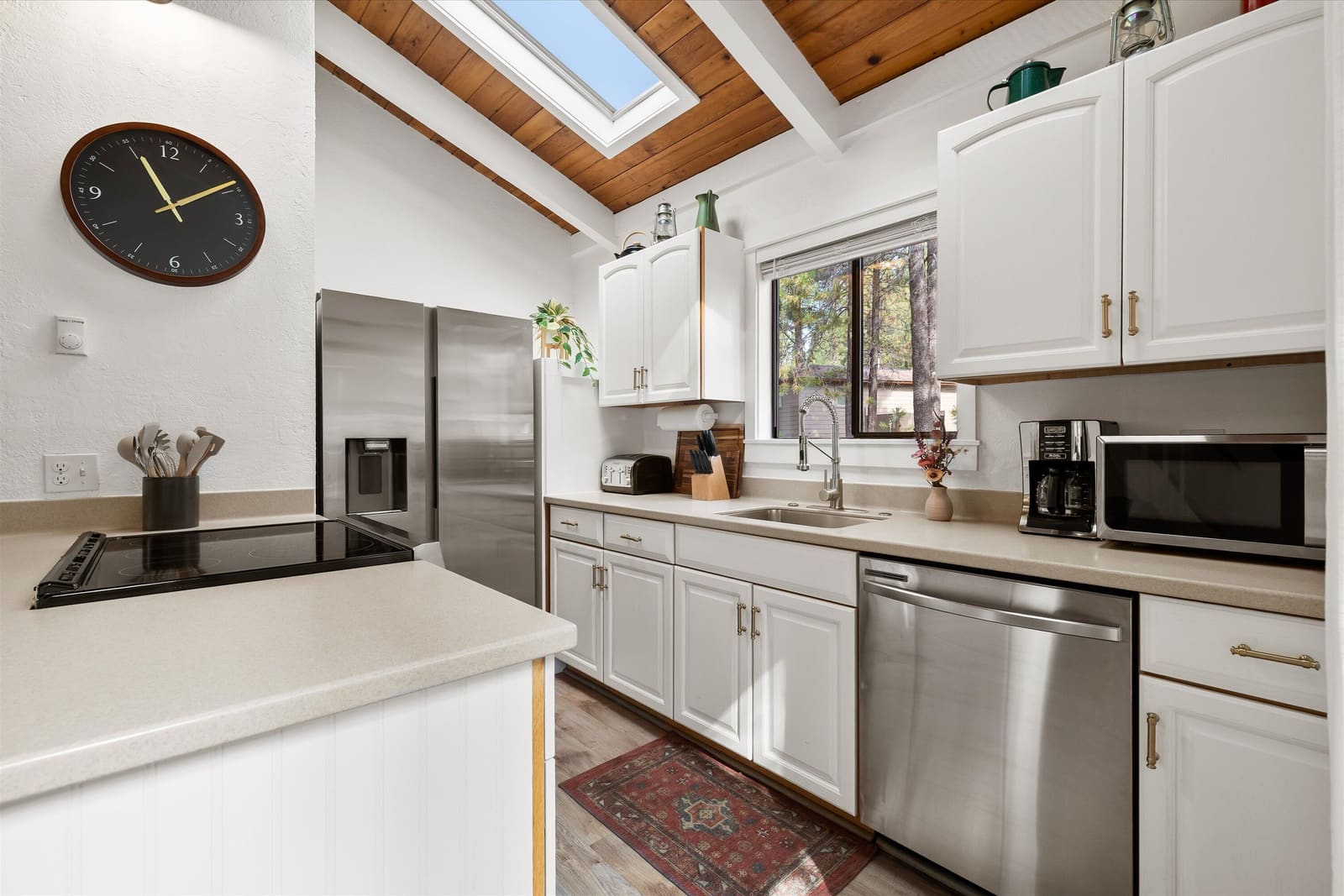 Kitchen with stainless appliances, dishwasher, coffee station, and a skylight over the counter